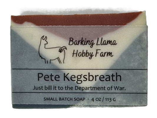 Bar of soap with 'Barking Llama Hobby Farm' branding and text on a white background. The soap is red, white, and blue.