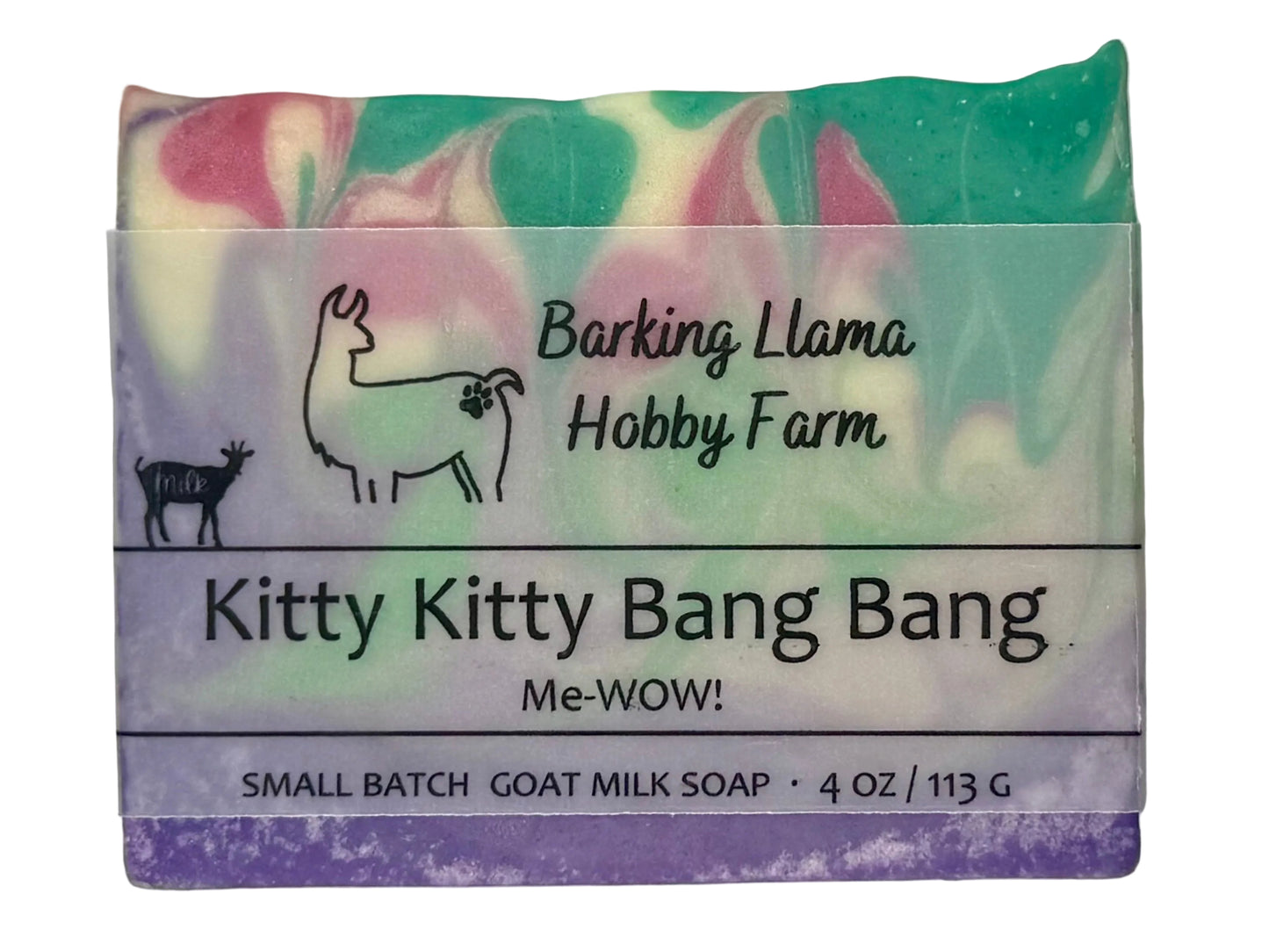 A small rectangular bar of goat milk soap with a marbled pastel pattern, wrapped in a paper label that reads 'Barking Llama Hobby Farm' and 'Kitty Kitty Bang Bang Me-WOW!'. The soap is purple, cream, pink, lime green, and turquoise. 