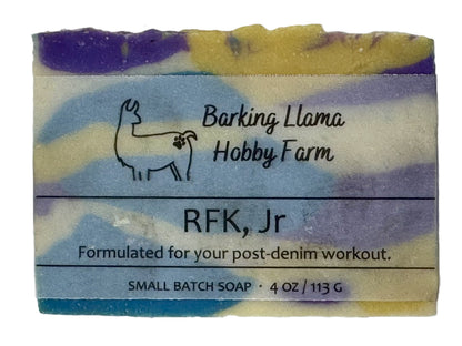 Soap bar with 'Barking Llama Hobby Farm' branding and text on a white background. The soap is purple, white, yellow, and blue.