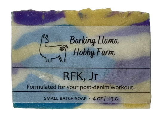 Soap bar with 'Barking Llama Hobby Farm' branding and text on a white background. The soap is purple, white, yellow, and blue.