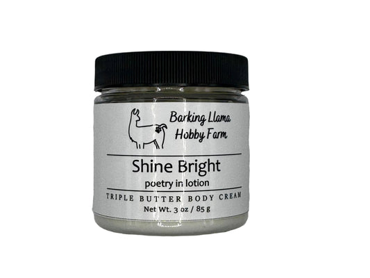 Clear jar with a black lid with white body cream inside. The label has a picture of a llama with the title of the lotion on the front.