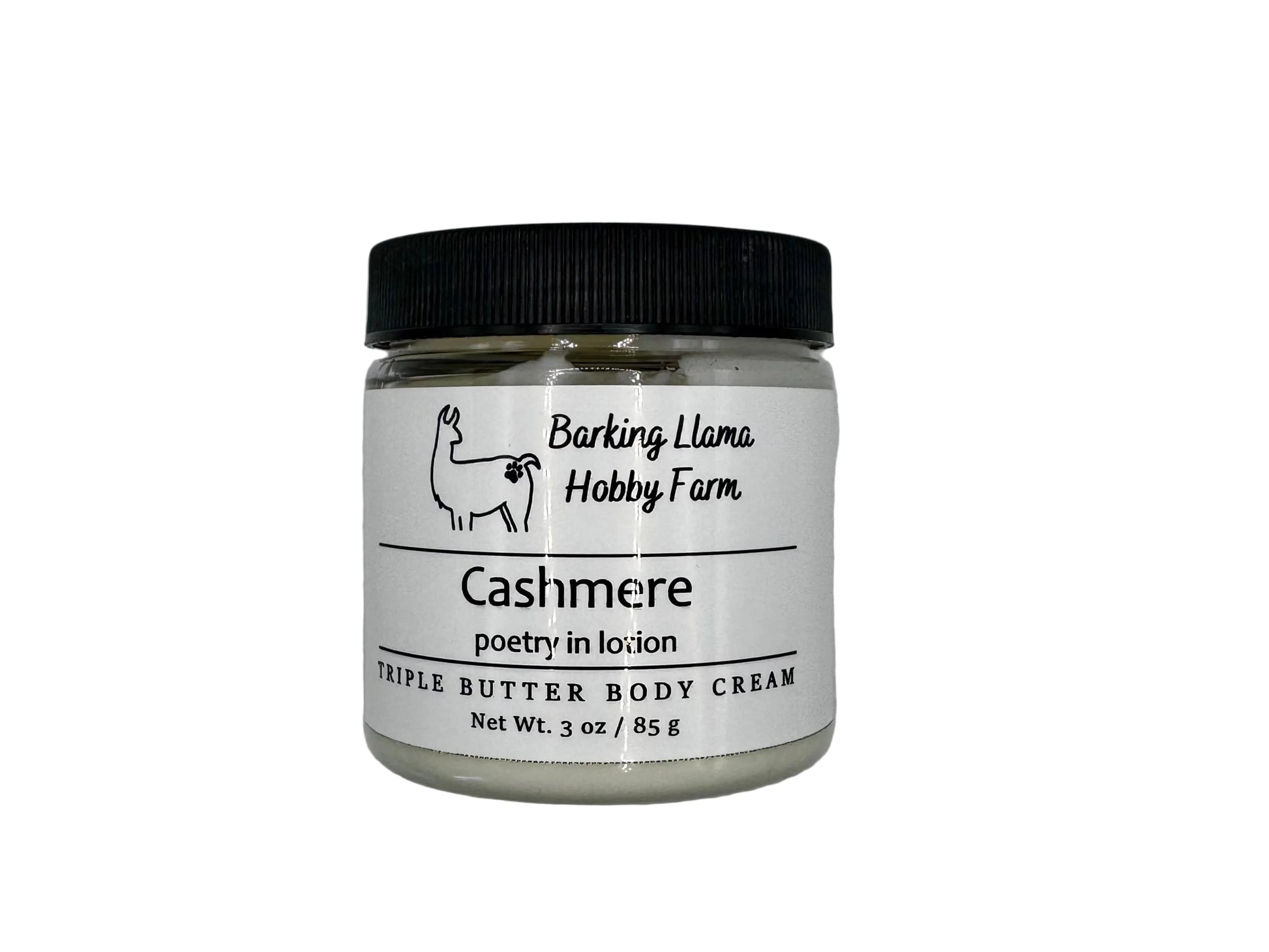 Clear jar with a black lid with white body cream inside. The label has a picture of a llama with the title of the lotion on the front.